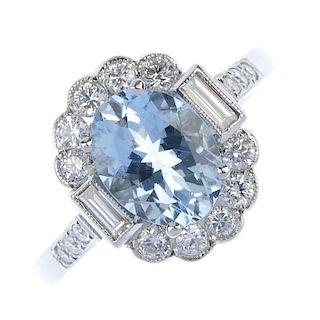 An aquamarine and diamond cluster ring. The oval-shape aquamarine, to the rectangular-shape diamond