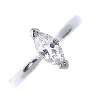 A platinum diamond single-stone ring. The marquise-shape diamond, to the tapered shoulders and plain