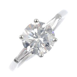 * A diamond single-stone ring. The brilliant-cut diamond, with tapered baguette-cut diamond sides, t