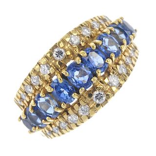An 18ct gold sapphire and diamond dress ring. The graduated oval-shape sapphire line, raised to bril