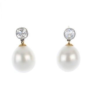A pair of diamond and cultured pearl ear pendants. Each designed as a cultured pearl drop, measuring