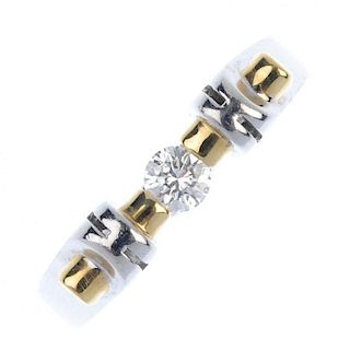 An 18ct gold diamond single-stone ring. Of bi-colour design, the brilliant-cut diamond, to the geome