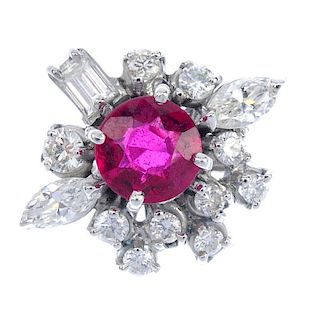 A synthetic ruby and diamond cluster ring. The circular-shape synthetic ruby, within a brilliant-cut