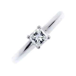 An 18ct gold diamond single-stone ring. The square-shape diamond, to the slightly tapered band. Acco