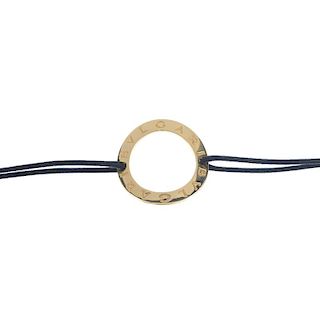 BULGARI - a bracelet. The curved circle, decorated with 'Bvlgari', to the cord bracelet and lobster