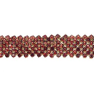 CHATILA - a garnet bracelet. Comprising seven rows of circular-shape garnets, to the partially conce