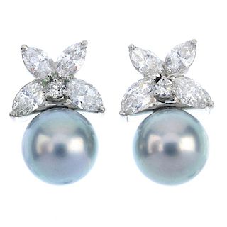 A pair of cultured pearl and diamond earrings. Each designed as a silvery-grey cultured pearl, to th