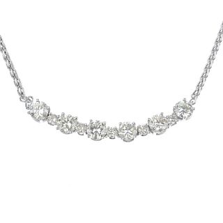 A diamond necklace. The front designed as a series of seven brilliant-cut diamonds, interspaced by s