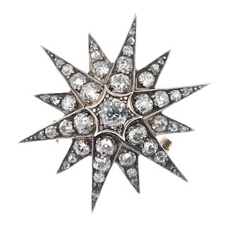 A late Victorian silver and 12ct gold diamond star brooch, circa 1890. The central old-cut diamond,