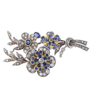 A sapphire and diamond floral brooch. The articulated flowers, to the tapered stem and foliate highl