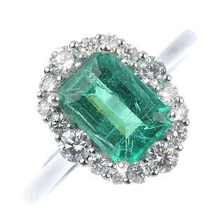 * An emerald and diamond cluster ring. The baguette-cut emerald, within a brilliant-cut diamond surr