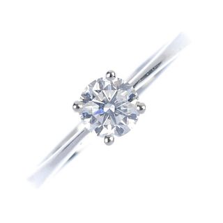 A diamond single-stone ring. The brilliant-cut diamond, within a claw setting, to the plain band. Es