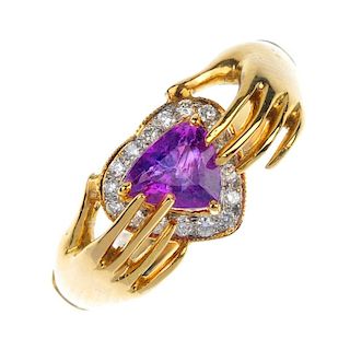 A sapphire claddagh ring. The triangular-shape pink sapphire, within a brilliant-cut diamond heart s