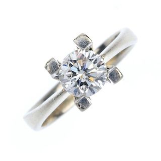 A diamond single-stone ring. The brilliant-cut diamond, to the tapered shoulders and plain band. Est