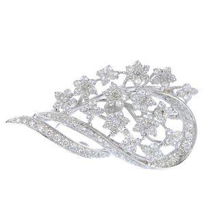 An 18ct white gold diamond floral brooch. Designed as a floral garland, with curved ribbon detail, s