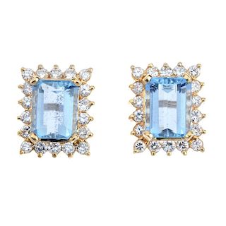 A pair of aquamarine and diamond cluster ear studs. Each designed as a rectangular-shape aquamarine,