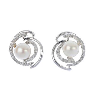 A pair of cultured pearl and diamond earrings. Each designed as a cultured pearl, measuring 7.4mms,