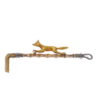 An early 20th gold century hunting brooch. Of tri-colour design, the textured running fox, set atop