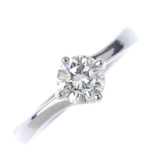 A platinum diamond single-stone ring. The brilliant-cut diamond, to the scrolling gallery and plain