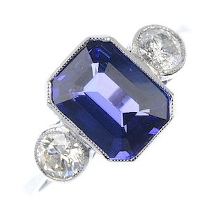 A tanzanite and diamond three-stone ring. The rectangular-shape tanzanite, with brilliant-cut diamon