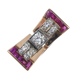 A mid 20th century 18ct gold diamond and ruby dress ring. Designed as a brilliant-cut diamond, to th