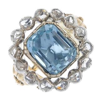 An aquamarine and diamond cluster ring. The rectangular-shape aquamarine, within a rose-cut diamond