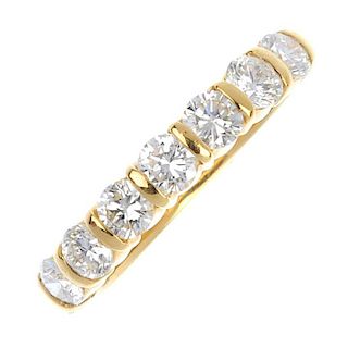 An 18ct gold diamond half-circle eternity ring. The brilliant-cut diamond line, to the plain band. E