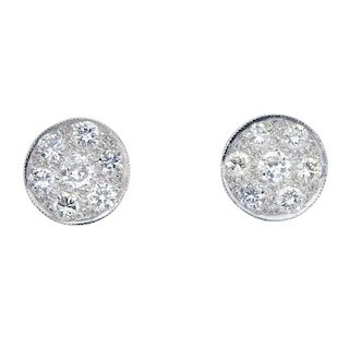 A pair of diamond ear studs. Each designed as a brilliant-cut diamond circular-shape panel. Estimate