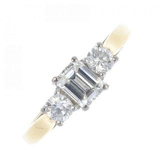 An 18ct gold diamond three-stone ring. The rectangular-shape diamond, to the brilliant-cut diamond s