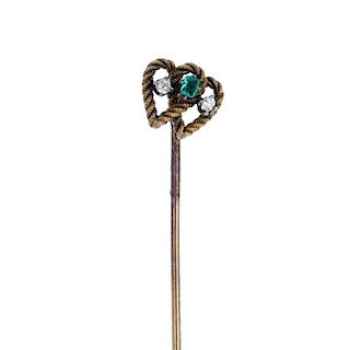 An emerald and diamond stickpin. Of openwork design, the rectangular-shape emerald, with old-cut dia
