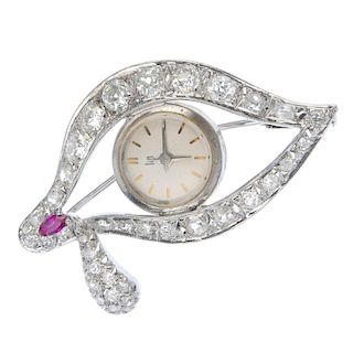 A mid 20th century diamond and synthetic ruby watch brooch. Designed as a stylised eye, the central
