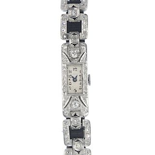 A lady's early 20th century diamond cocktail watch. The rectangular-shape cream dial with Arabic num