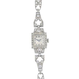 A lady's early 20th century diamond cocktail watch. The square-shape white dial, with black Arabic n