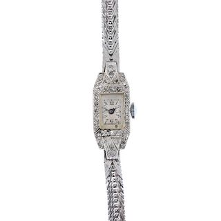 A lady's mid 20th century diamond manual wind cocktail watch. The rectangular-shape white dial with