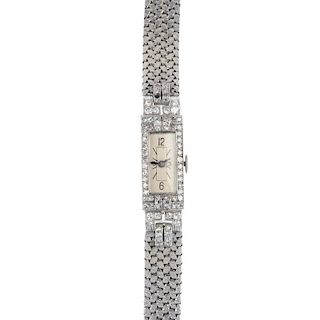A diamond cocktail watch. The rectangular-shape silvered dial, with Arabic numeral and baton hour ma