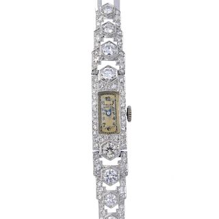 A lady's mid 20th century platinum diamond manual wind cocktail watch. The rectangular-shape cream d