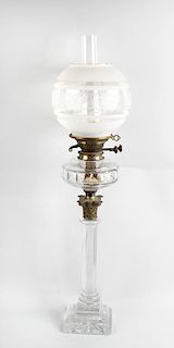 A glass paraffin lamp, with frosted spherical shaped shade over duplex burner, glass and brass Corin