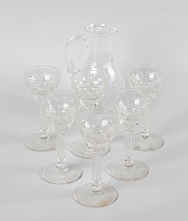 A glass sherry jug plus six glasses. The jug of pear form raised upon circular footed base, and deco