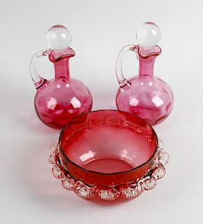 A set of eight glasses, each having cranberry glass bowls with clear glass stems and spreading bases
