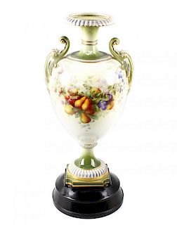 A large Royal Worcester porcelain twin handled vase, the ovoid shaped body upon a moulded plinth bas