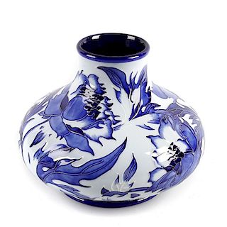 A modern Moorcroft pottery vase. Of squat form, decorated to the whole with Florian-style flowers of