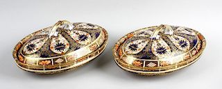 A pair of Royal Crown Derby oval dishes and covers. Of shallow form raised upon a short footed base,