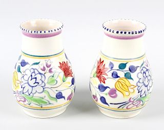 A pair of Poole pottery vases. Each of pear form with floral border upon a white ground, marked bene