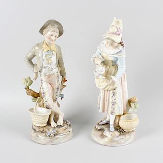 A pair of German bisque figures. Modelled as a male and female each stood upon a naturalistic ground