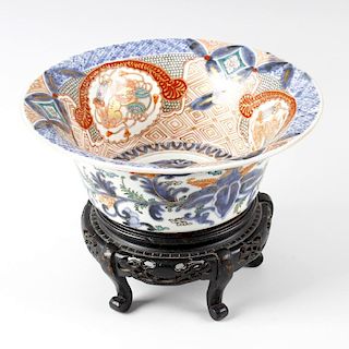 A 19th century Japanese Imari bowl. Of flared circular form, internally decorated with temple dogs a