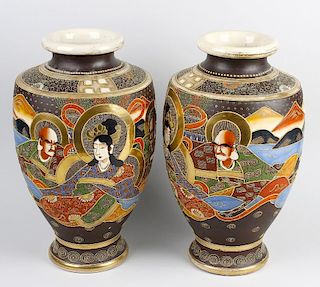 A large pair of 20th century Japanese vases. Of shouldered pear form decorated with figures before a