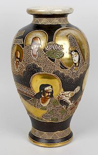 A Japanese Satsuma vase. Taisho period c. 1930, of baluster form with tube-lined decoration of deiti