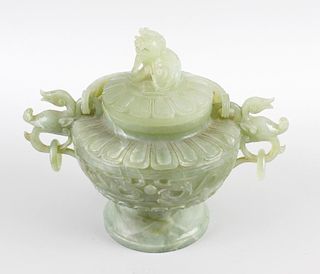 A Chinese carved green hard stone bowl and cover, the body carved with dual dragon and pearl panels