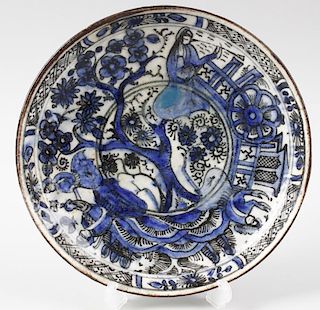 Three Middle Eastern faience pottery dishes. The first with convex centre, decorated with figures an