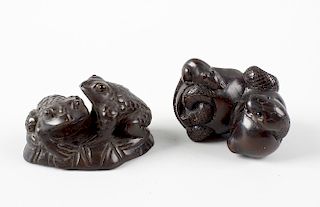 Two Japanese hardwood netsuke. The first modelled with two toads on a lily pad, 1.75, (4.75 cm) long